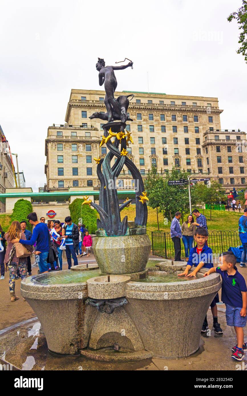 A lot of travelers Fountain and statue of the goddess Diana in front of Green Park Tube station exit.Piccadilly and the pedestrian Queen`s Walk,London Stock Photo